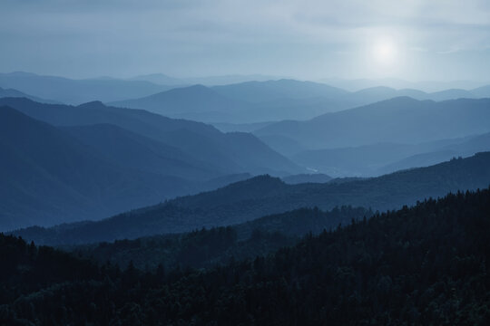 Panorama of dark blue mountain landscape. Horizontal image.