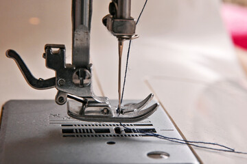 heated thread into the sewing machine needle