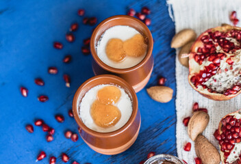 Top view, curd with topping peach jam, on ceramic jars.