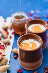 Fotobehang Curd with topping peach jam on ceramic jars © MiguelAngel