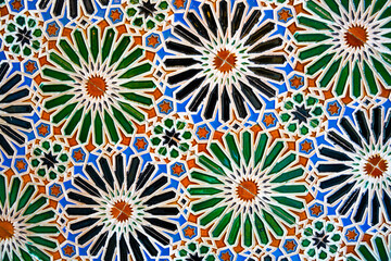 Geometric seamless andalusian moroccan islamic arabic round star floral pattern in green orange...