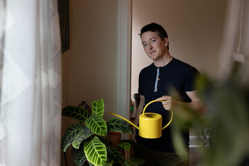 lifestyle portrait of caucasian nonbinary person with plants © annie