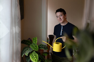 lifestyle portrait of caucasian nonbinary person with plants © annie