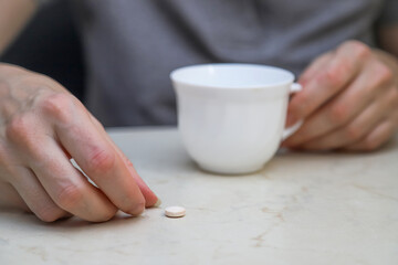 The middle-aged woman taking a pill