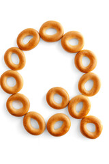 Letter Q bagel. Bagels font. Alphabet from set of small dry bagels isolated on white background. ABC symbols.