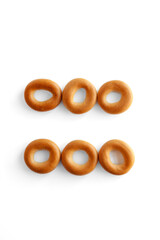 Fototapeta premium Symbol = bagel. Bagels font. Alphabet from set of small dry bagels isolated on white background. ABC symbols.