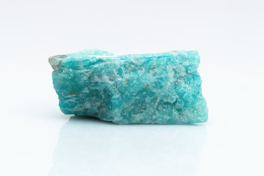 Natural amazonite gemstone isolated on white background. A bluish-green crystal on a white background. A variety of potassium feldspar microcline