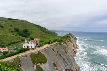 View of Basque coast with traditional houses along rock formation