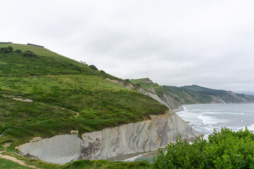 Green hills and flysch rock formations near ocean in Zumaia spain