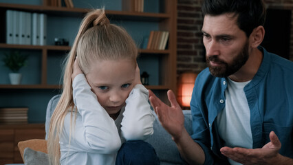 Sad offended little child daughter feel stress cover ears ignoring scream caucasian angry annoyed man dad shouting on girl for bad behavior and disobedience scolding kid problem of parenting in family - obrazy, fototapety, plakaty