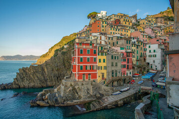Fototapeta na wymiar Awe Riomaggiore town on Liguria coast in Italy - fantastic small colorful buildings on rocky hill . Travel on Christmas