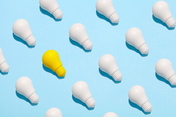 light bulb success business ideas creativity and inspiration concepts on blue background. Goal achievements flat lay minimalist composition