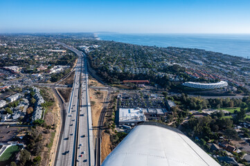 Aerial view of automobiles on Interstate 5 by Encinitas in San Diego California on a clear day with the Pacific ocean in the background