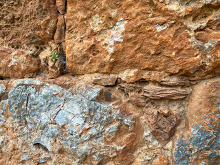 Background, texture, stone wall of round stones cobblestones bricks natural surface natural sharp convex rough stone cobblestone with cracks