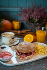 breakfast with ham sandwich, potatoes, coffee and juice