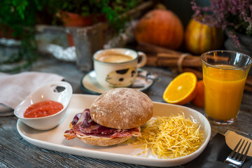 breakfast with ham sandwich, potatoes, coffee and juice