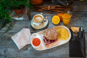 breakfast with ham sandwich, potatoes, coffee and juice