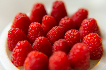 Raspberry close-up on a beautiful stand, summer fruit. Fruits are good for health. Proper nutrition, raw food.