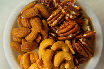 Mix Walnuts, pecan, almonds, cashews on a beautiful stand, Healthy Nuts.