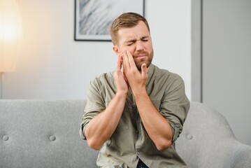 Man suffering from tooth ache in morning