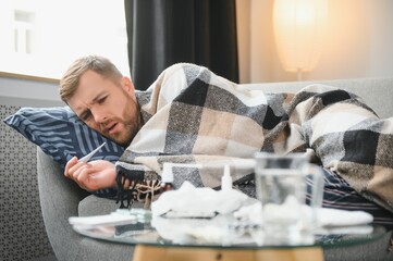 It's cold at home in wintertime. Man freezing in his house in winter because of broken thermostat....