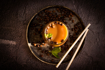 Coffee with milk, mint on a dark background