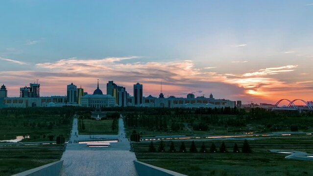 Panorama with beautiful sunset of the Astana city timelapse and the president's residence Akorda with park. View from the Palace of Peace and Reconciliation. Nur-Sultan city, Kazakhstan