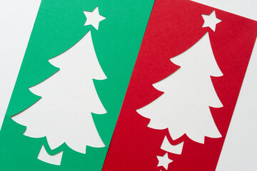 Fototapeta na wymiar red and green holiday paper tree designs on blank paper