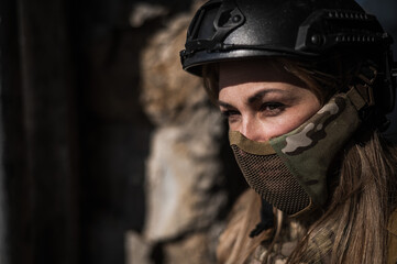 Portrait of a caucasian woman in a protective suit. Female FA soldier in camouflage uniform.