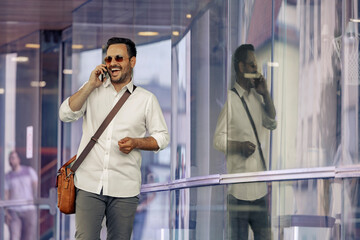 Smiling man talking on mobile phone