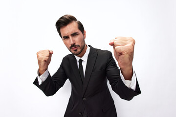 Portrait of a man in an expensive business suit close-up wide-angle lens pulling his hands to fight into the camera with his mouth open screaming his fists up on a white background, copy space