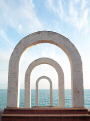 Arches on the seashore, retro monument in Sochi, Russia. Beautiful sea view before sunset, minimalistic landscape