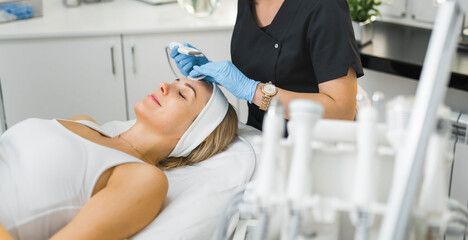 Skincare and wellness concept. Happy smiling caucasian middle-aged woman in white tank-top lying...