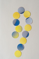 yellow and yellow blue cardboard paper spheres on blank paper