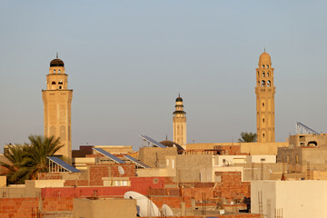 Cityscape view of Tozeur city in Tunisia during sunset with minarets of mosque in the background....