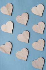 wooden hearts on plain blue paper