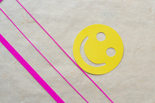 smiley rolling down a pink hill