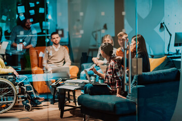 Businesswoman in wheelchair having business meeting with team at modern office. A group of young...