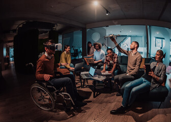 Fototapeta na wymiar Business persons with a disability at work in modern open space coworking office on team meeting using virtual reality goggles.