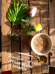 still life with coffee, flowers and spoon on wood background 