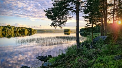 View over quiet lake in sunset.