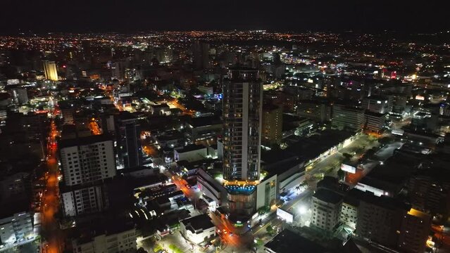 High-rise Building Of Embassy Suites by Hilton Santo Domingo Hotel With City Views At Night In Dominican Republic. - aerial