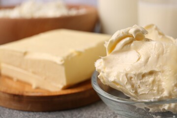 Tasty homemade butter and dairy products on grey table, closeup