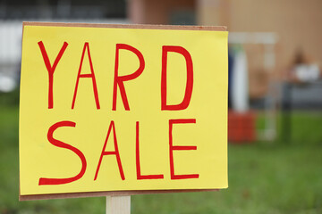 Sign Yard sale written on yellow paper outdoors, closeup