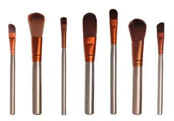 Set with different makeup brushes for applying cosmetic products on white background
