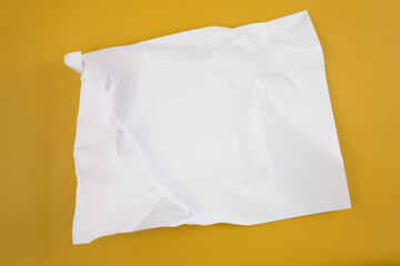 Abstract crumpled paper texture isolated in yellow background