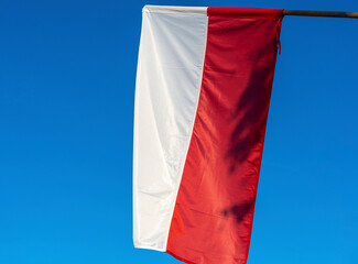 Polish flags against blue sky. Flags of Poland on the wind.
Independence day celebration