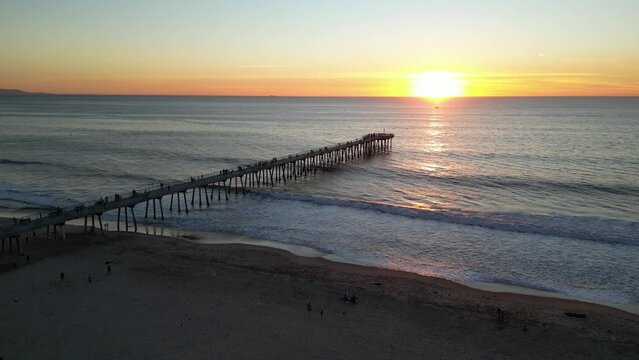 HERMOSA BEACH PIER AT SUNSET | 4K DRONE OF WAVES CRASHING AND PEOPLE WALKING ON THE PIER | RAINBOW LIFEGUARD TOWER AND PIER SHOT ALSO FEATURED