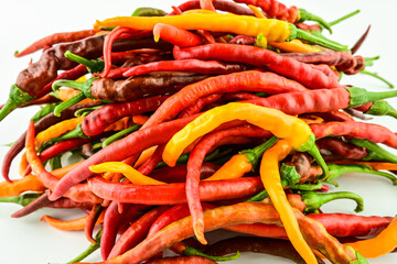 A bunch of fresh peppers on a white background