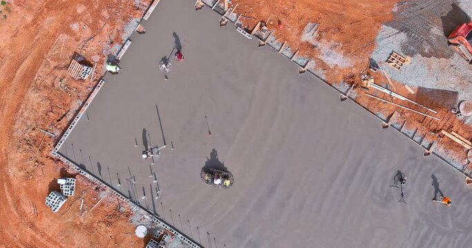 Process polishing and leveling cement screed mortar floors on construction site in process construction